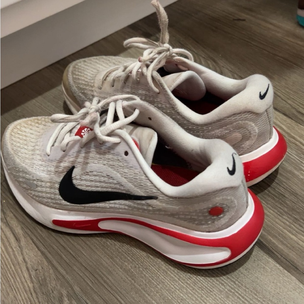 Nike Kids White Sneakers with Black Swoosh and Red Accents